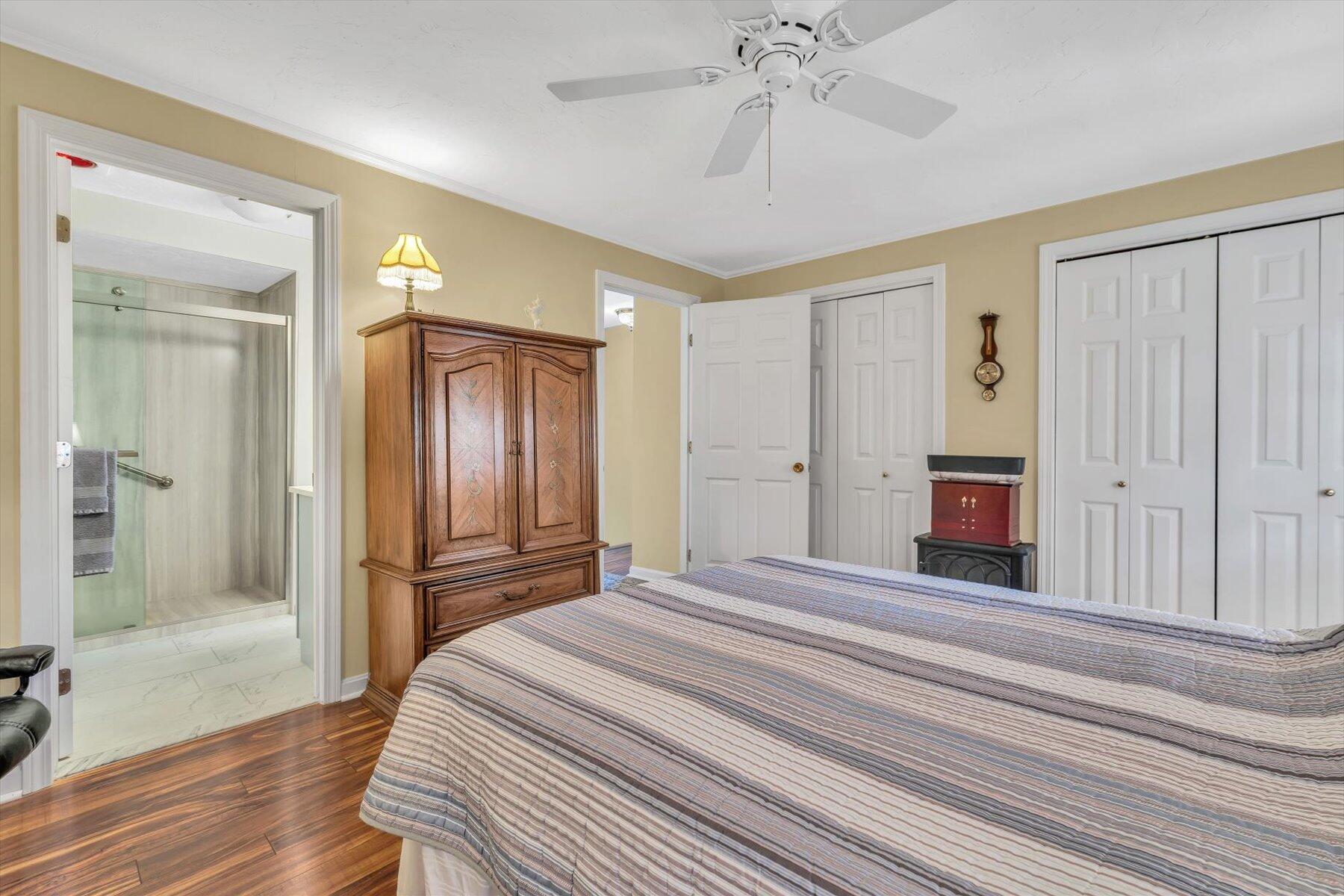 441 Buck Island Road, Unit B1 West Yarmouth, MA 02673 - Photo 20 of 31 a bedroom with a bed and a chandelier