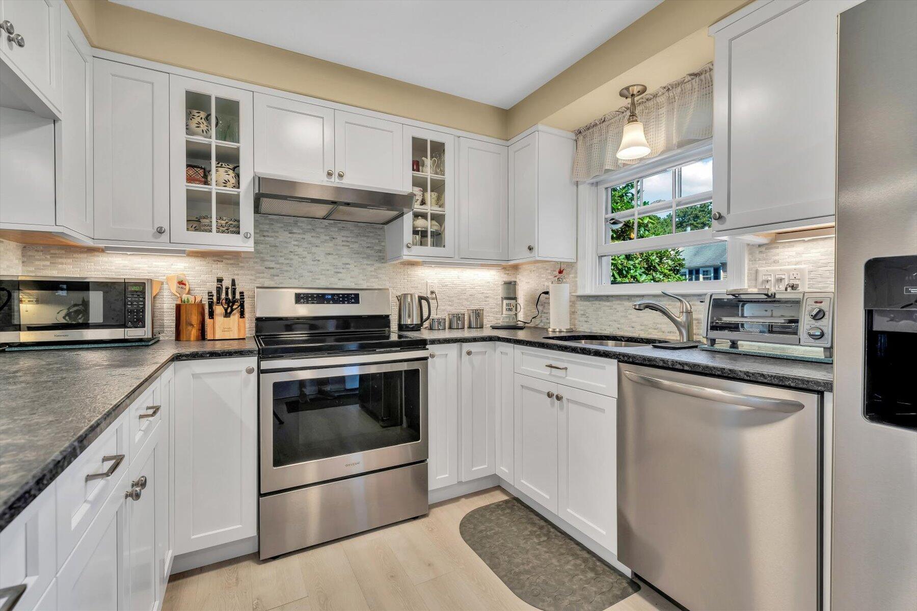 441 Buck Island Road, Unit B1 West Yarmouth, MA 02673 - Photo 4 of 31 a kitchen with stainless steel appliances granite countertop a sink and cabinets