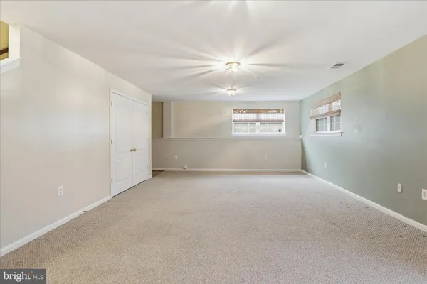 a balcony with wooden floor and outdoor seating
