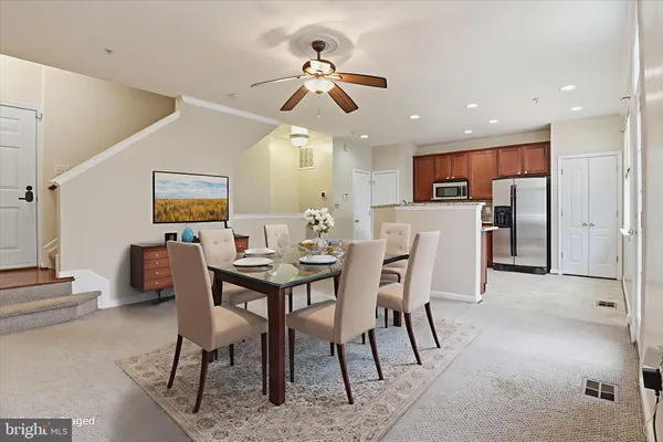 a view of a livingroom with furniture and ceiling fan