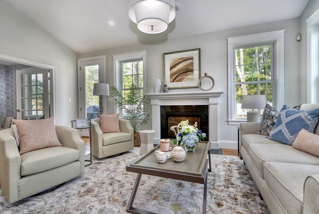 67 Rowell Road, Unit 67 Middleton , MA 01923 - Photo 14 of 40 a living room with furniture and a fireplace