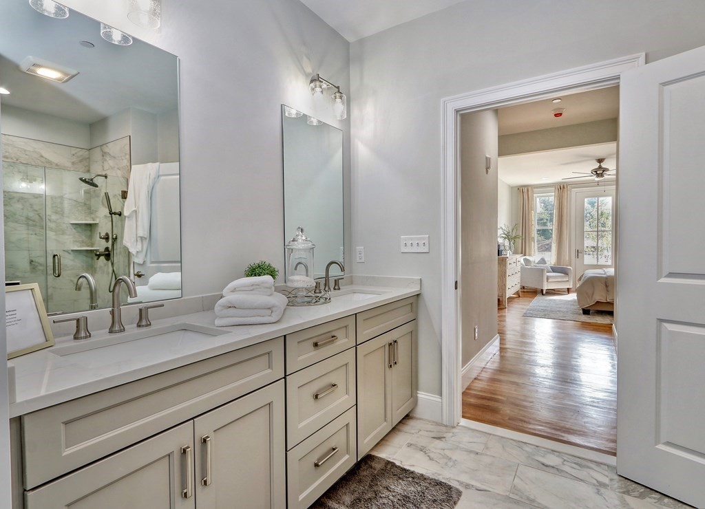 67 Rowell Road, Unit 67 Middleton , MA 01923 - Photo 21 of 40 a spacious bathroom with a double vanity sink and a mirror