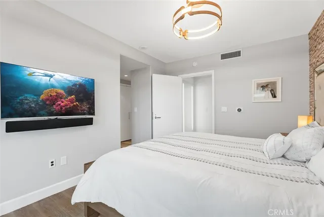 a bedroom with a bed and wall painting