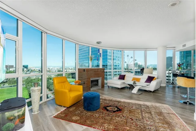 a living room with furniture and a floor to ceiling window