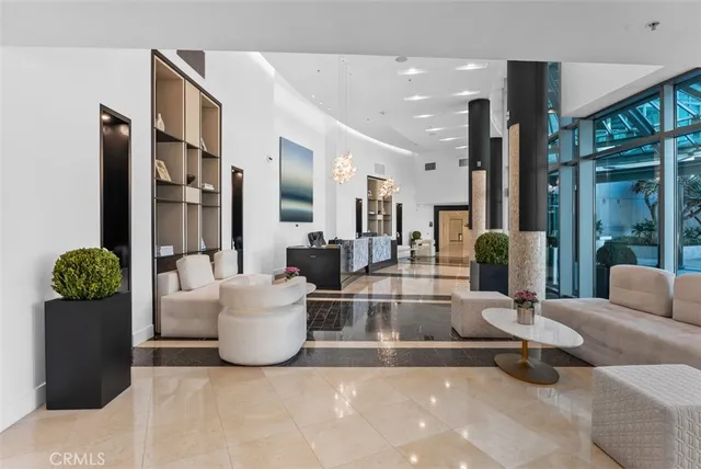 a living room with fireplace furniture and a large window
