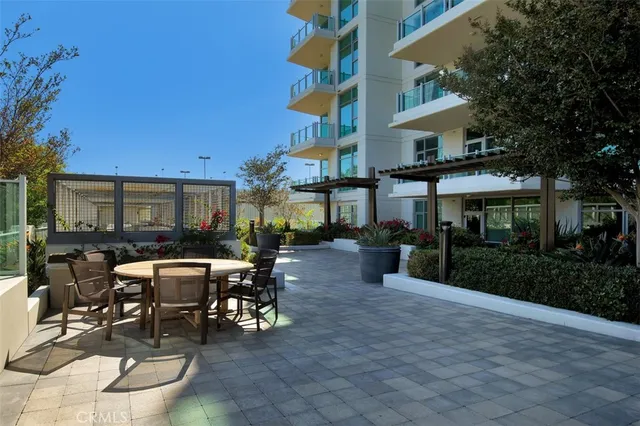 a view of a patio with table and chairs and potted plants