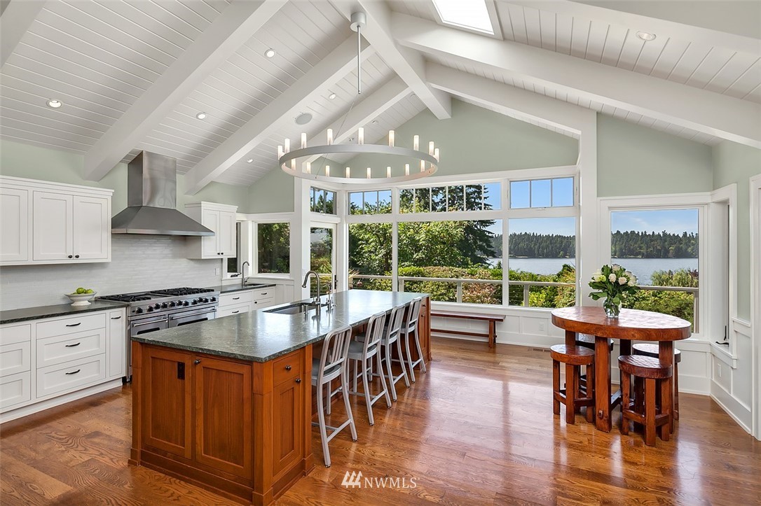 17 Brook Bay Road Mercer Island, WA 98040 - Photo 7 of 25 a dining hall with stainless steel appliances granite countertop a stove top oven a dining table and chairs