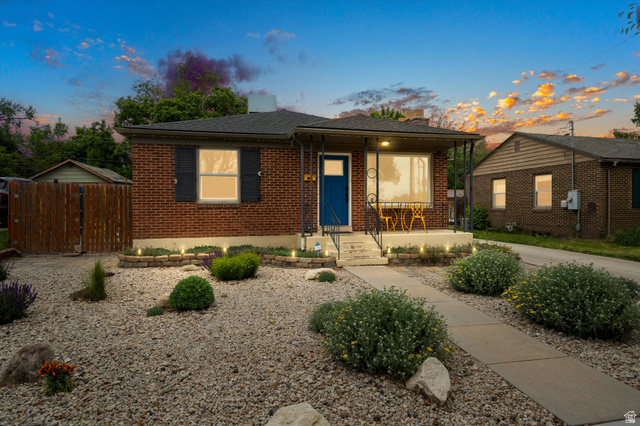 961 33rd Street Ogden, UT 84403 - Photo 3 of 39 Brick home with a covered front porch and a distinctive blue entry door. Low maintenance xeriscape front yard.