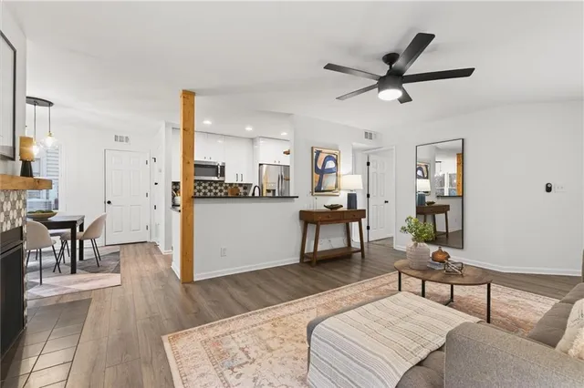 a living room with furniture a fireplace and a flat screen tv