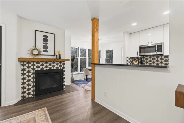 a dining room with furniture a chandelier and wooden floor