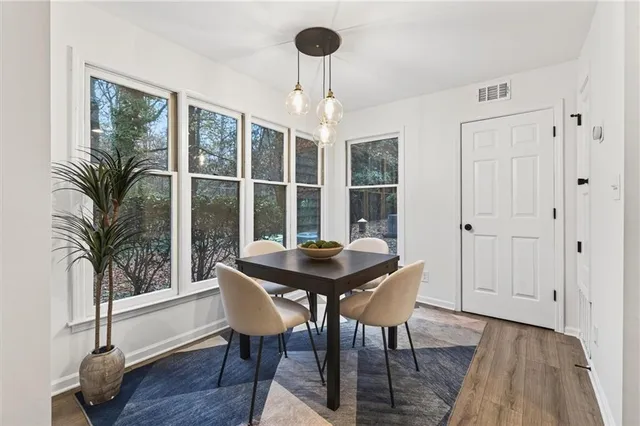 a dining room with furniture and wooden floor