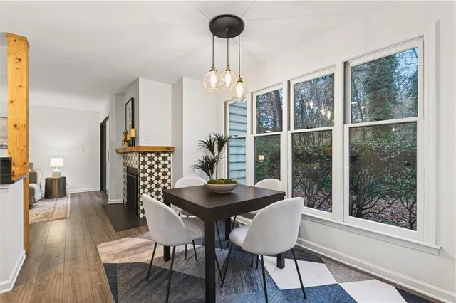 a hallway view with stainless steel appliances granite countertop a stove and wooden floor
