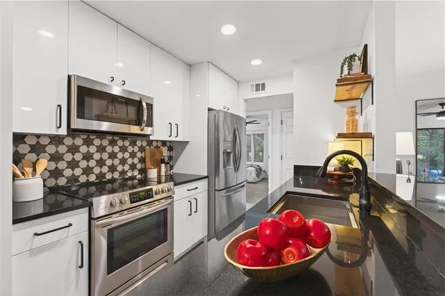 a kitchen with a sink stove and cabinets