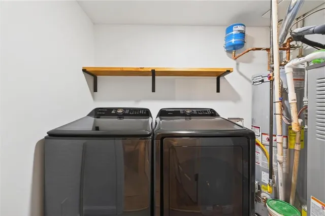 a spacious bedroom with a bed and a chandelier