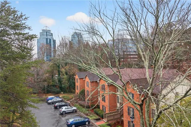 a backyard of a house with large trees and signage