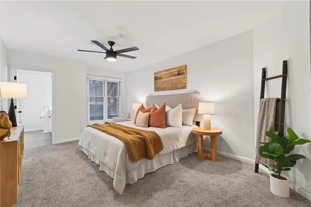 a bedroom with a bed and a dresser with mirror