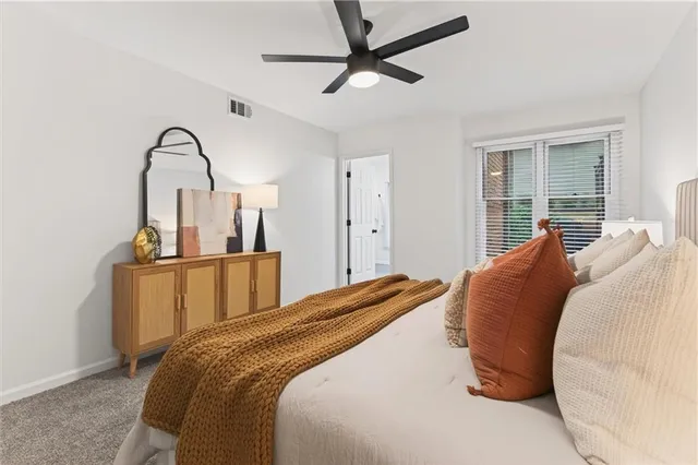 a bedroom with bed and a chandelier