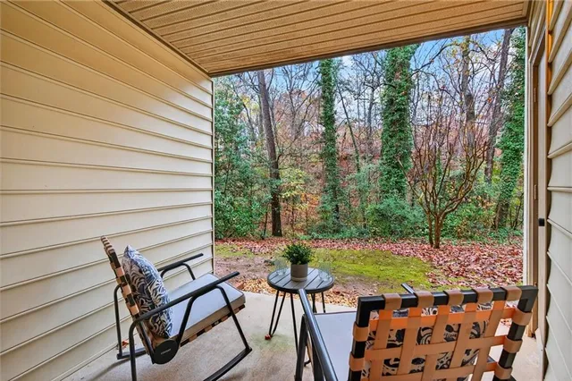 a view of a patio with couple of chairs and a fountain