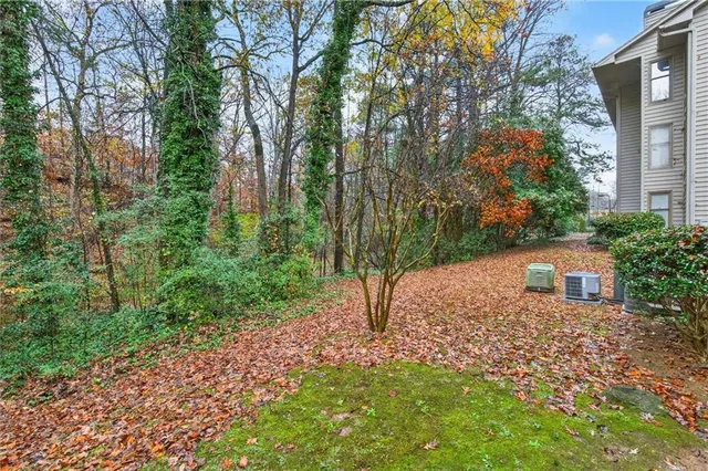 a view of a house with a yard and sitting area