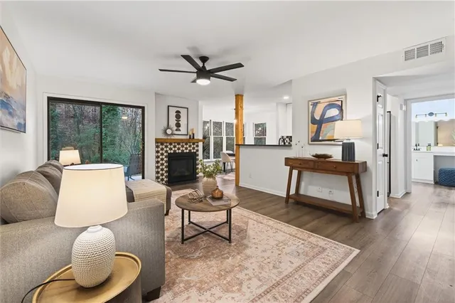 a living room with furniture a fireplace and a rug