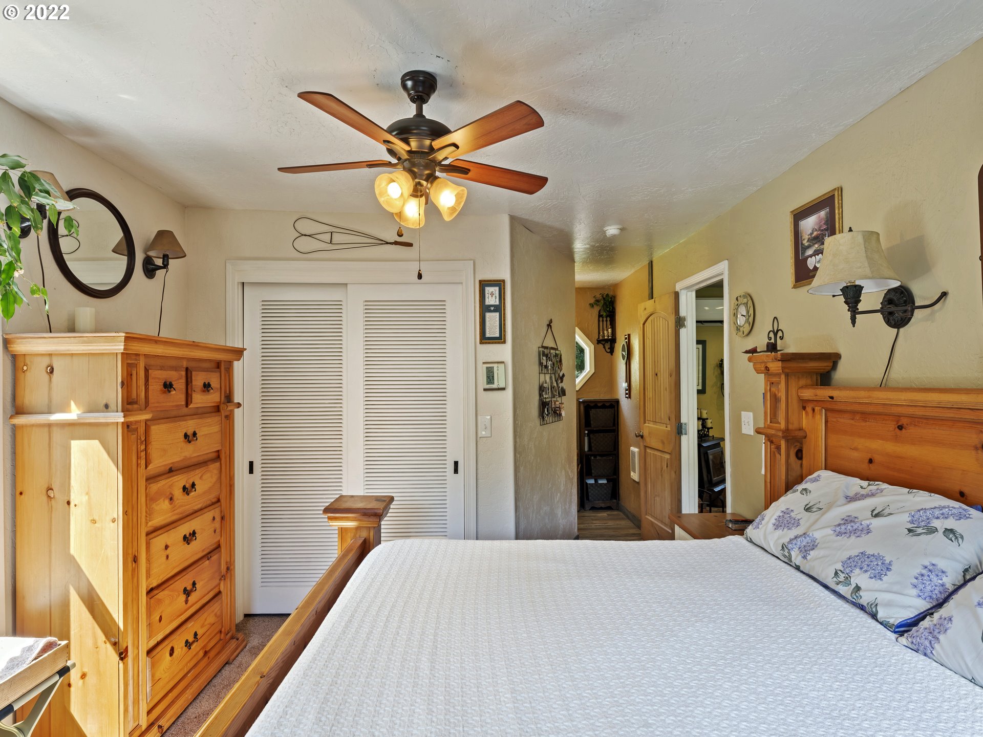 3530 Highway 38 Drain, OR 97435 - Photo 12 of 32 a bedroom with a bed and a chandelier