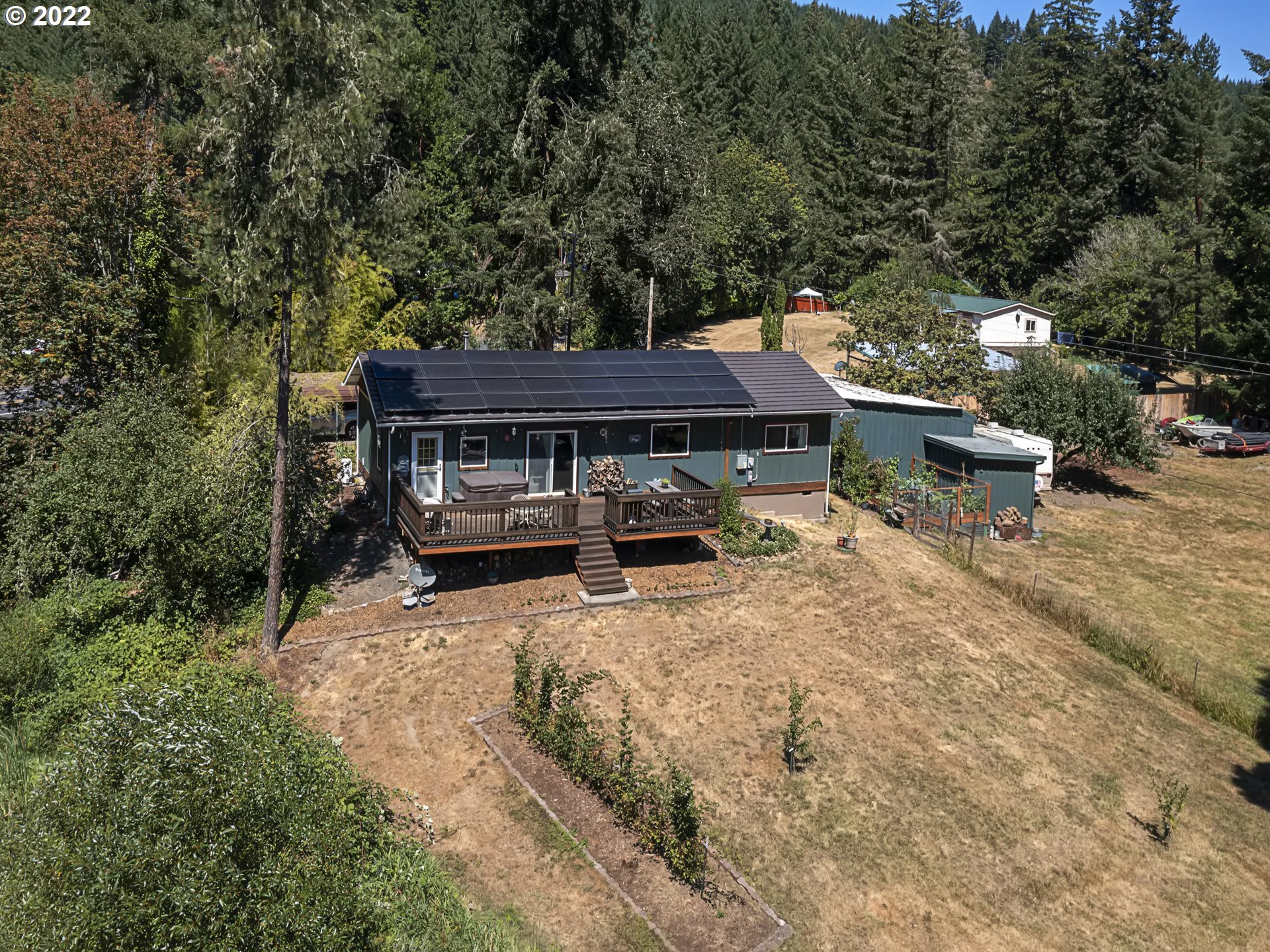 3530 Highway 38 Drain, OR 97435 - Photo 28 of 32 a view of backyard with a table and chairs under an umbrella