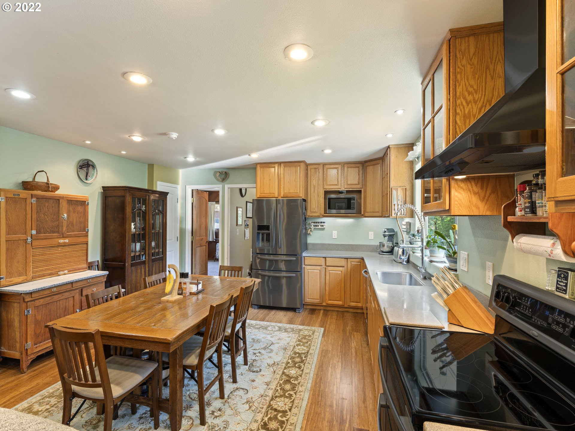3530 Highway 38 Drain, OR 97435 - Photo 7 of 32 a dining room with stainless steel appliances kitchen island granite countertop a stove top oven a dining table and chairs