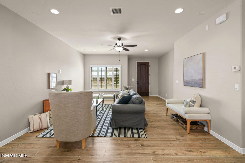 664 Paseo Musical Street El Paso, TX 79928 - Photo 12 of 50 a living room with furniture a table and wooden floor