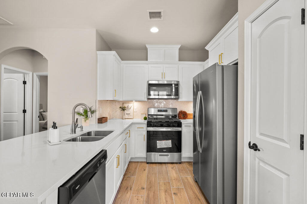 664 Paseo Musical Street El Paso, TX 79928 - Photo 21 of 50 a kitchen with stainless steel appliances a refrigerator sink and cabinets