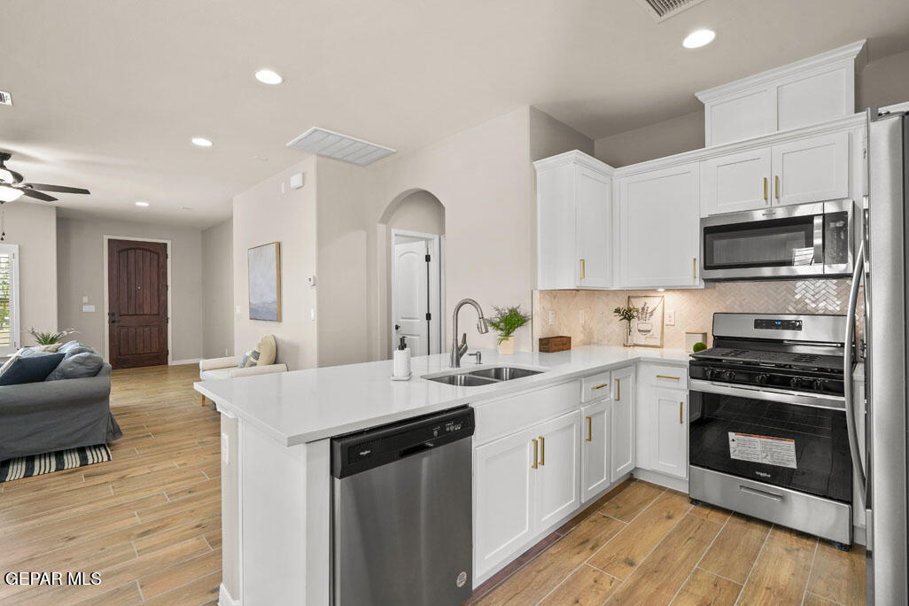 664 Paseo Musical Street El Paso, TX 79928 - Photo 22 of 50 a kitchen with stainless steel appliances kitchen island granite countertop a sink and cabinets