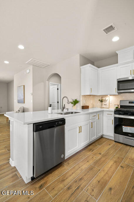 664 Paseo Musical Street El Paso, TX 79928 - Photo 23 of 50 a kitchen with a sink cabinets and wooden floor
