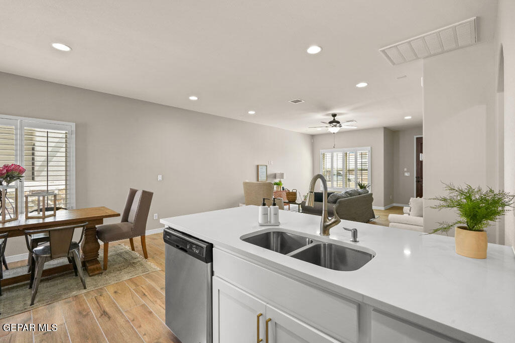 664 Paseo Musical Street El Paso, TX 79928 - Photo 25 of 50 a kitchen with a table chairs sink and white cabinets