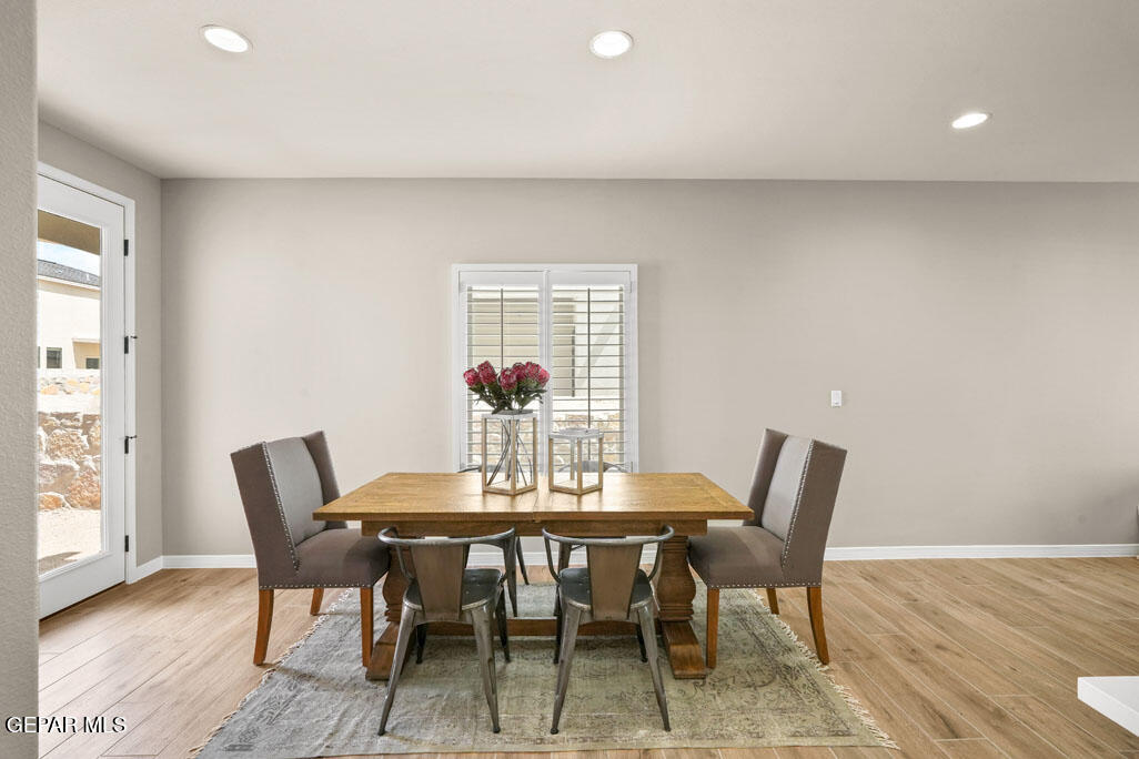 664 Paseo Musical Street El Paso, TX 79928 - Photo 26 of 50 a view of a dining room with furniture and wooden floor