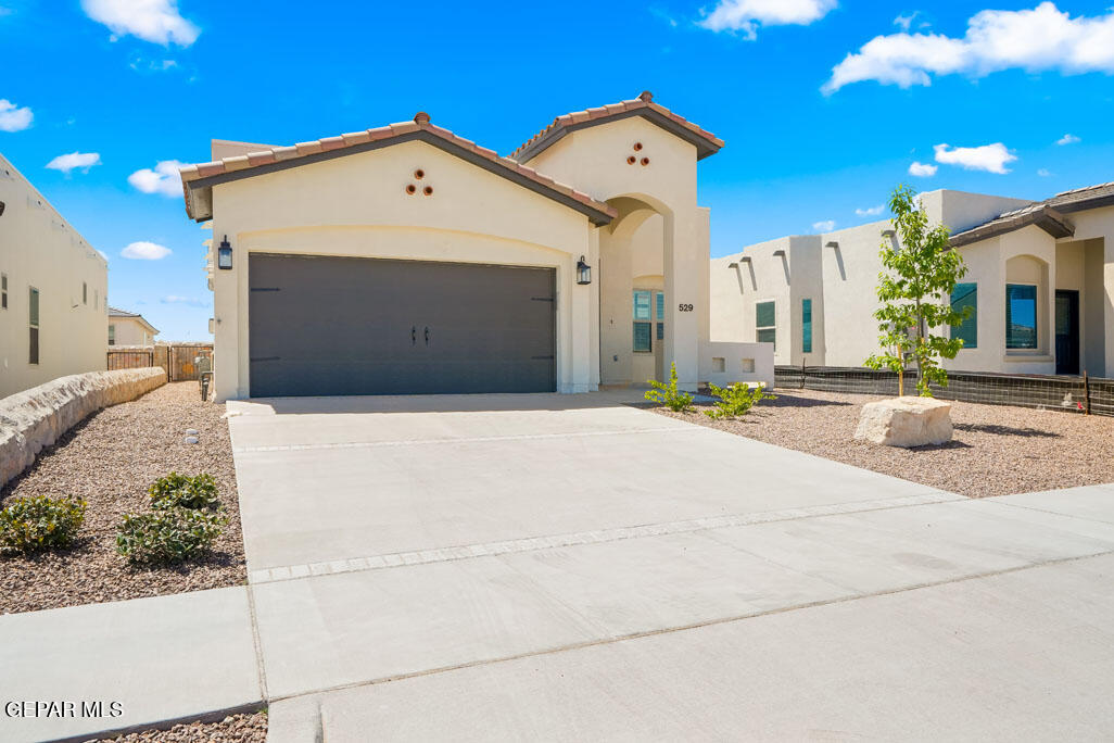 664 Paseo Musical Street El Paso, TX 79928 - Photo 3 of 50 a front view of a house with a yard