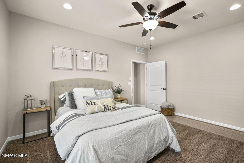 664 Paseo Musical Street El Paso, TX 79928 - Photo 32 of 50 a bedroom with a bed and a ceiling fan