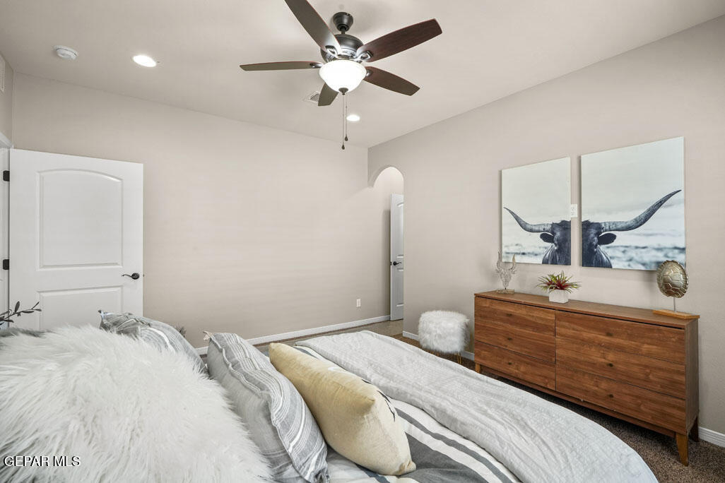 664 Paseo Musical Street El Paso, TX 79928 - Photo 33 of 50 a bedroom with a bed and a chandelier