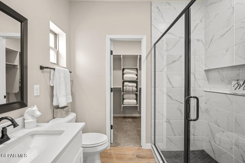 664 Paseo Musical Street El Paso, TX 79928 - Photo 35 of 50 a bathroom with a granite countertop sink toilet and shower