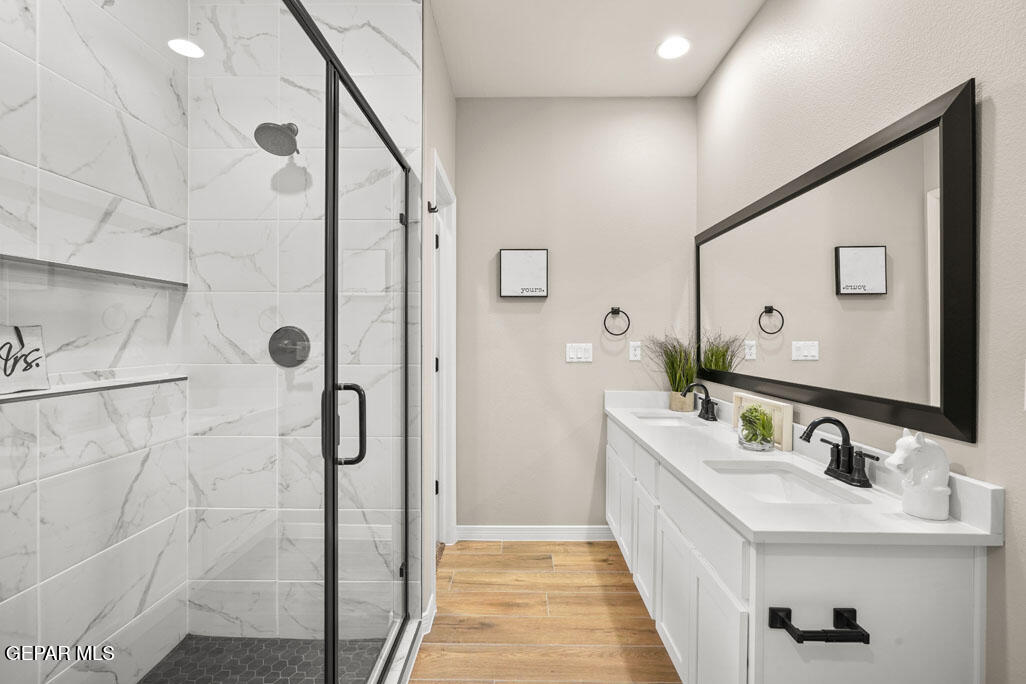 664 Paseo Musical Street El Paso, TX 79928 - Photo 36 of 50 a bathroom with a double vanity sink mirror and shower