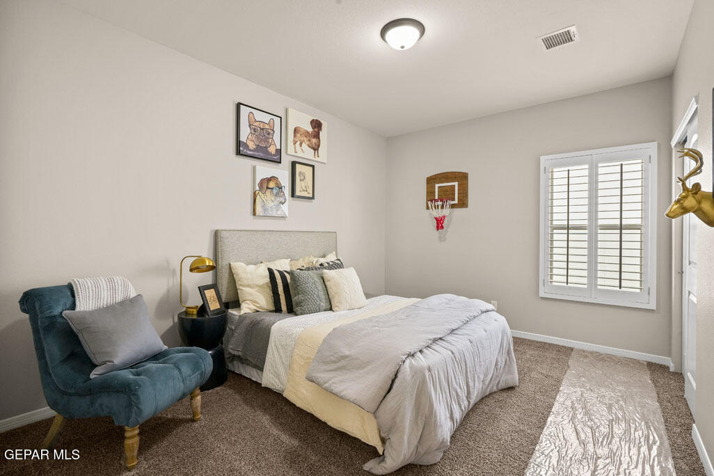 664 Paseo Musical Street El Paso, TX 79928 - Photo 44 of 50 a bed room with a bed and a chair