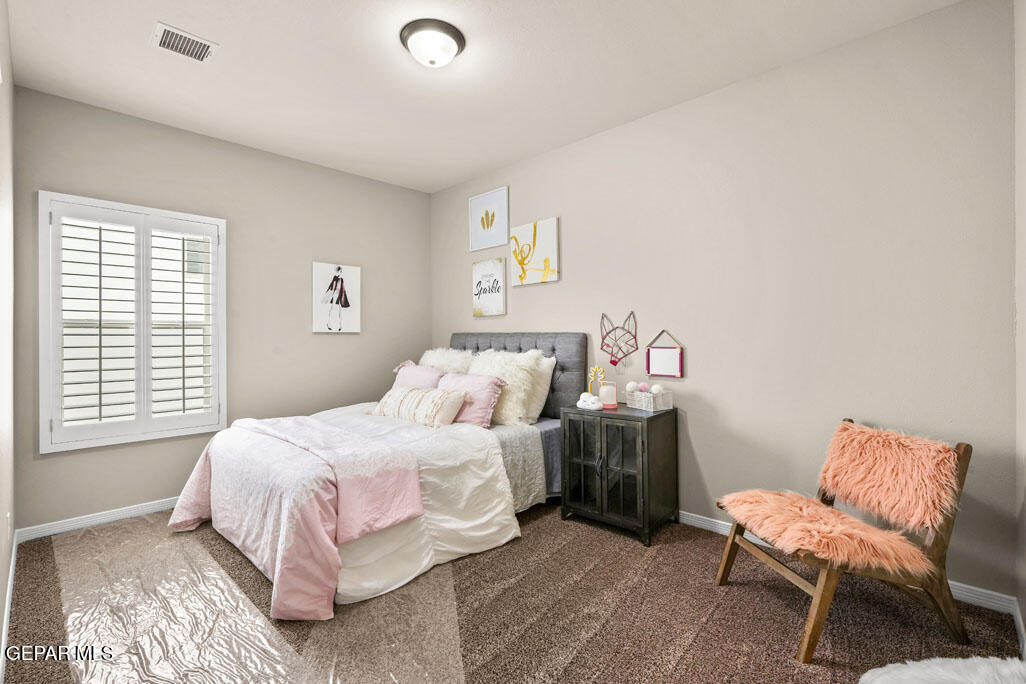 664 Paseo Musical Street El Paso, TX 79928 - Photo 46 of 50 a bedroom with a bed and a chair