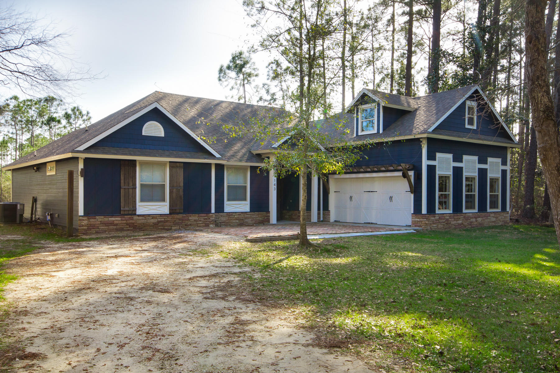 143 Pepper Tree Road Santa Rosa Beach, FL 32459 - Photo 1 of 28 a view of a house with a yard and large tree