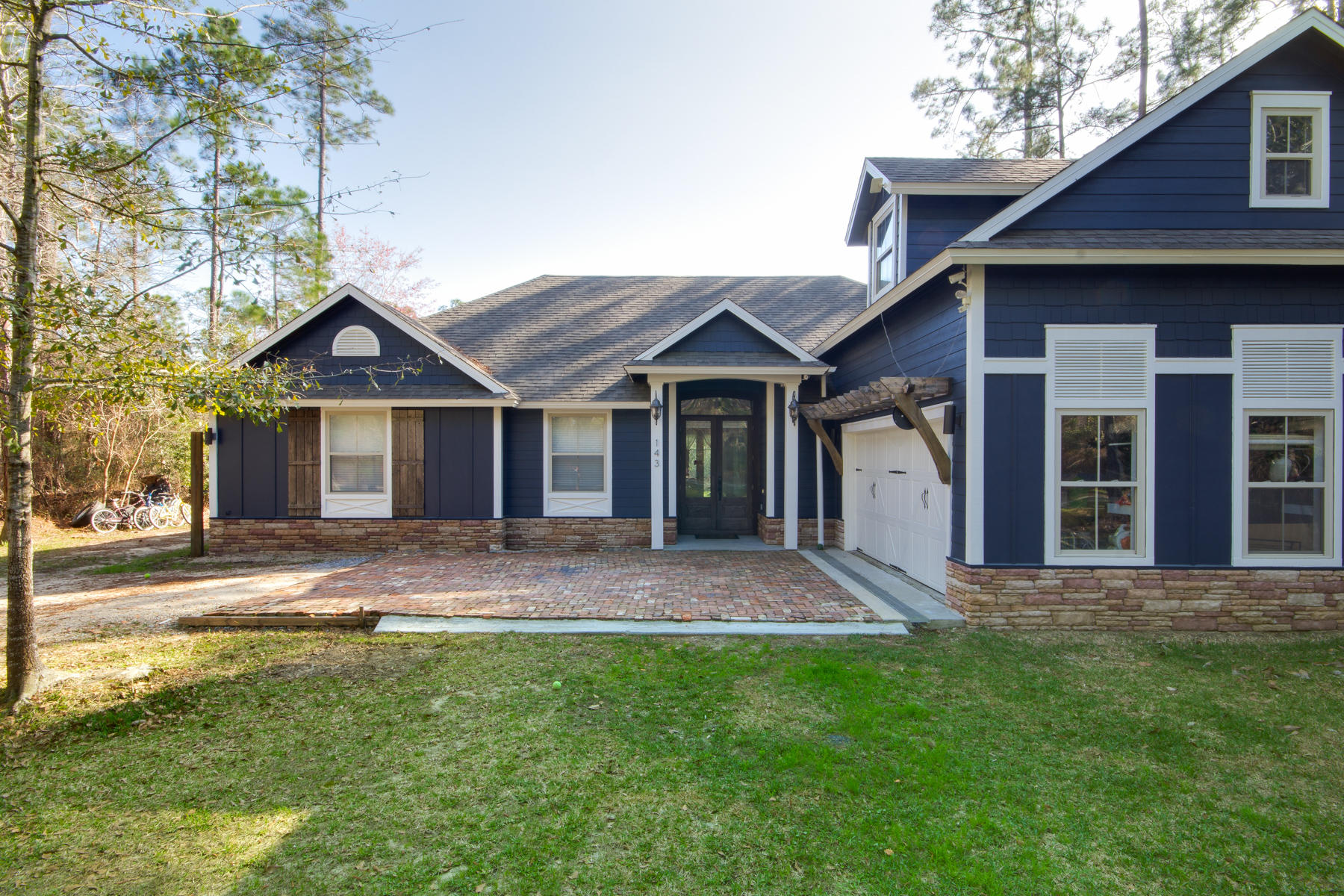 143 Pepper Tree Road Santa Rosa Beach, FL 32459 - Photo 2 of 28 a front view of a house with a garden