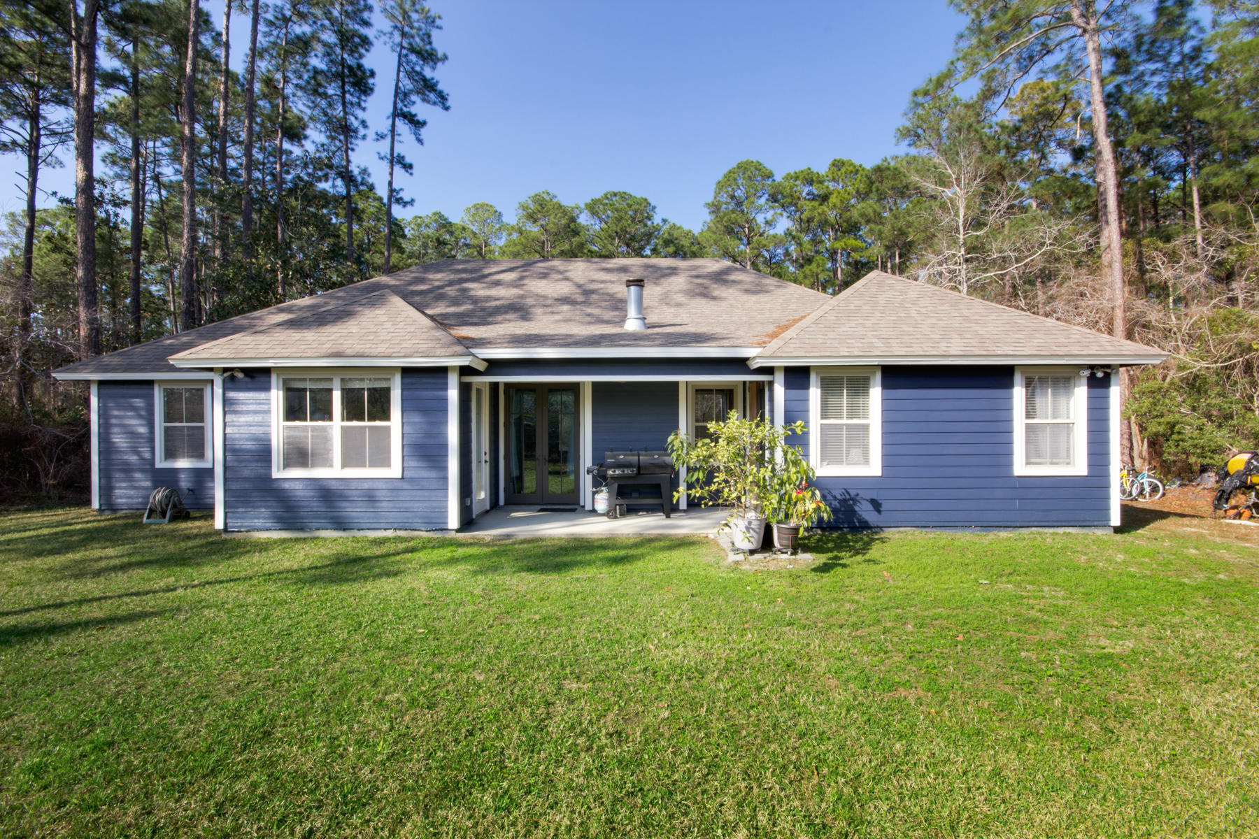 143 Pepper Tree Road Santa Rosa Beach, FL 32459 - Photo 5 of 28 a front view of a house with a garden and trees