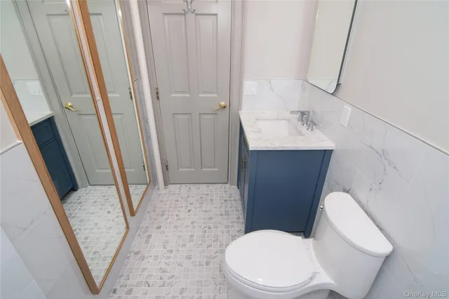 a white toilet sitting next to a sink