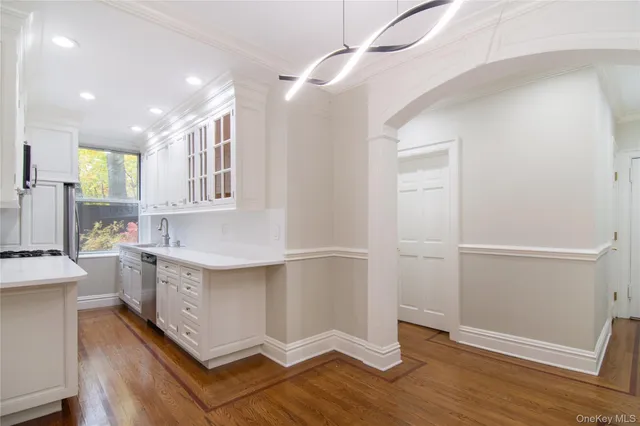 a room with a white cabinets and window