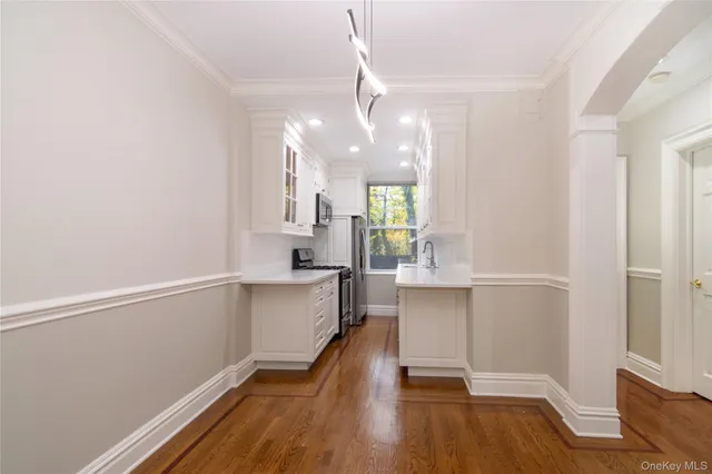 a view of a kitchen with wooden floor and a window
