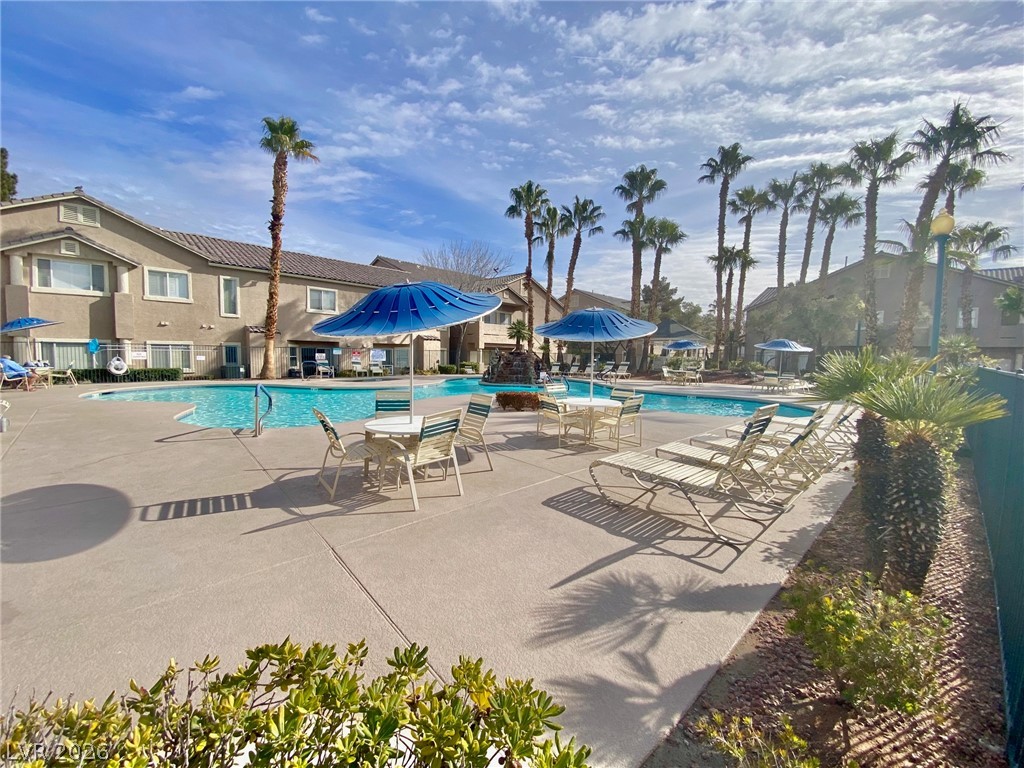 2000 Turquoise Ridge Street, Unit 204 Las Vegas, NV 89117 - Photo 9 of 29 Palm-lined resort-style pool with ample lounge seating and shaded tables invites relaxation.