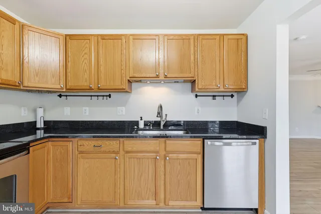 a kitchen with granite countertop cabinets and window