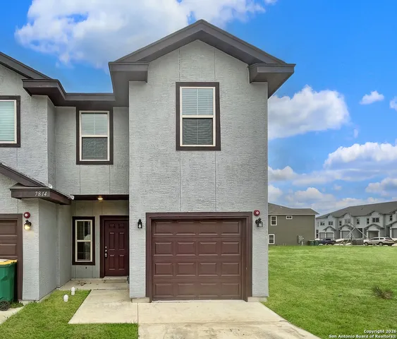 a front view of a house with a yard