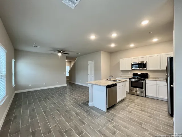 a kitchen with stainless steel appliances granite countertop a stove and a sink